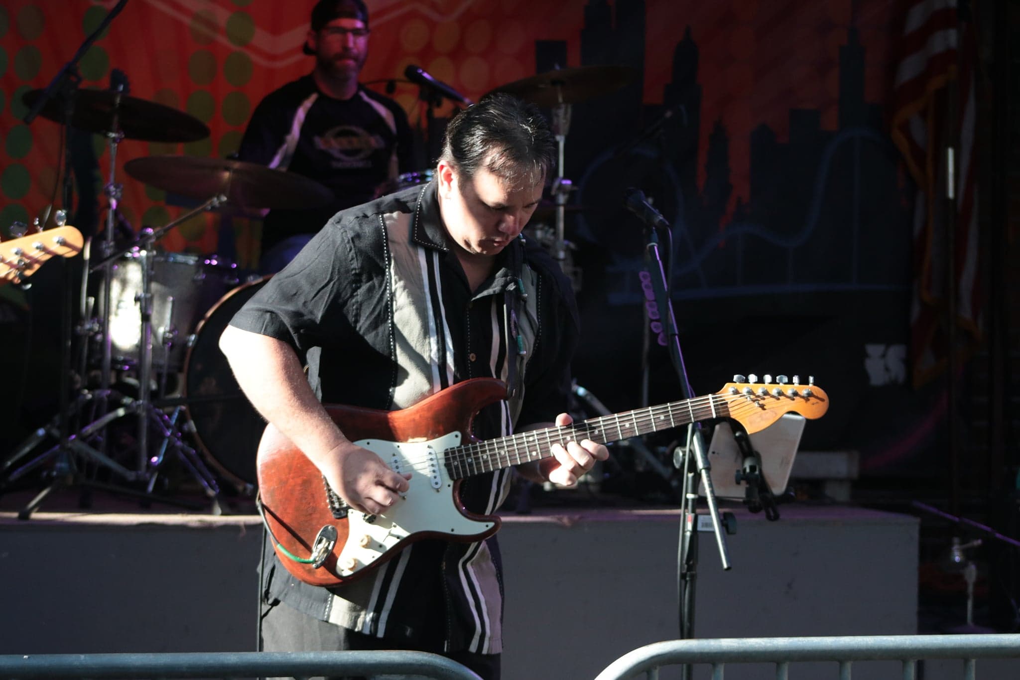James Pitts playing guitar live with the band.