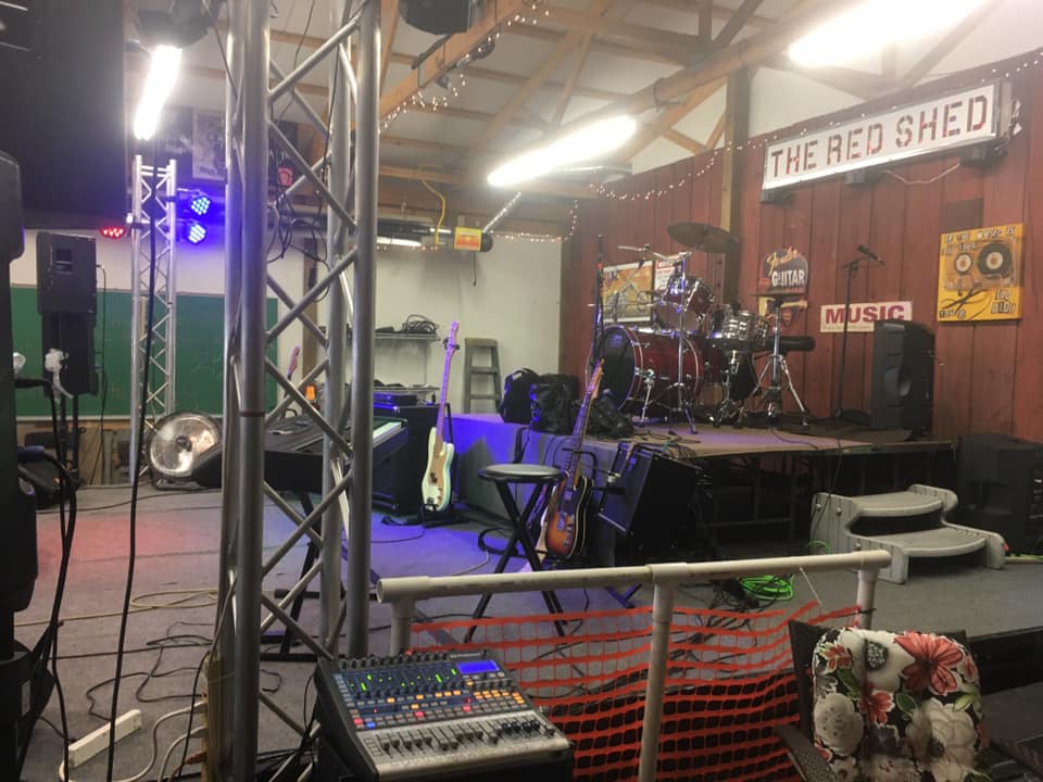 Stage and crowd under purple lights at Red Shed.